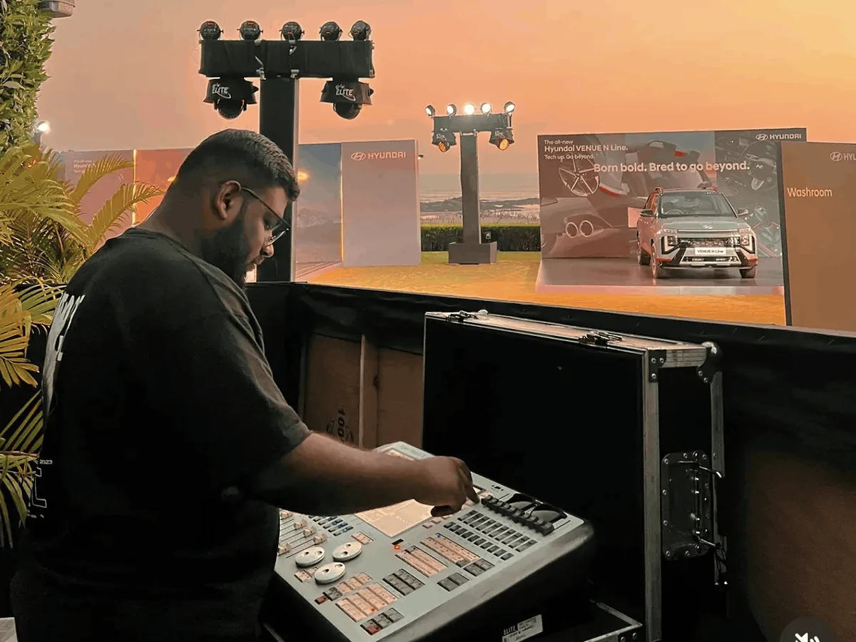 IIED lighting student programming a lighting console at a live brand event