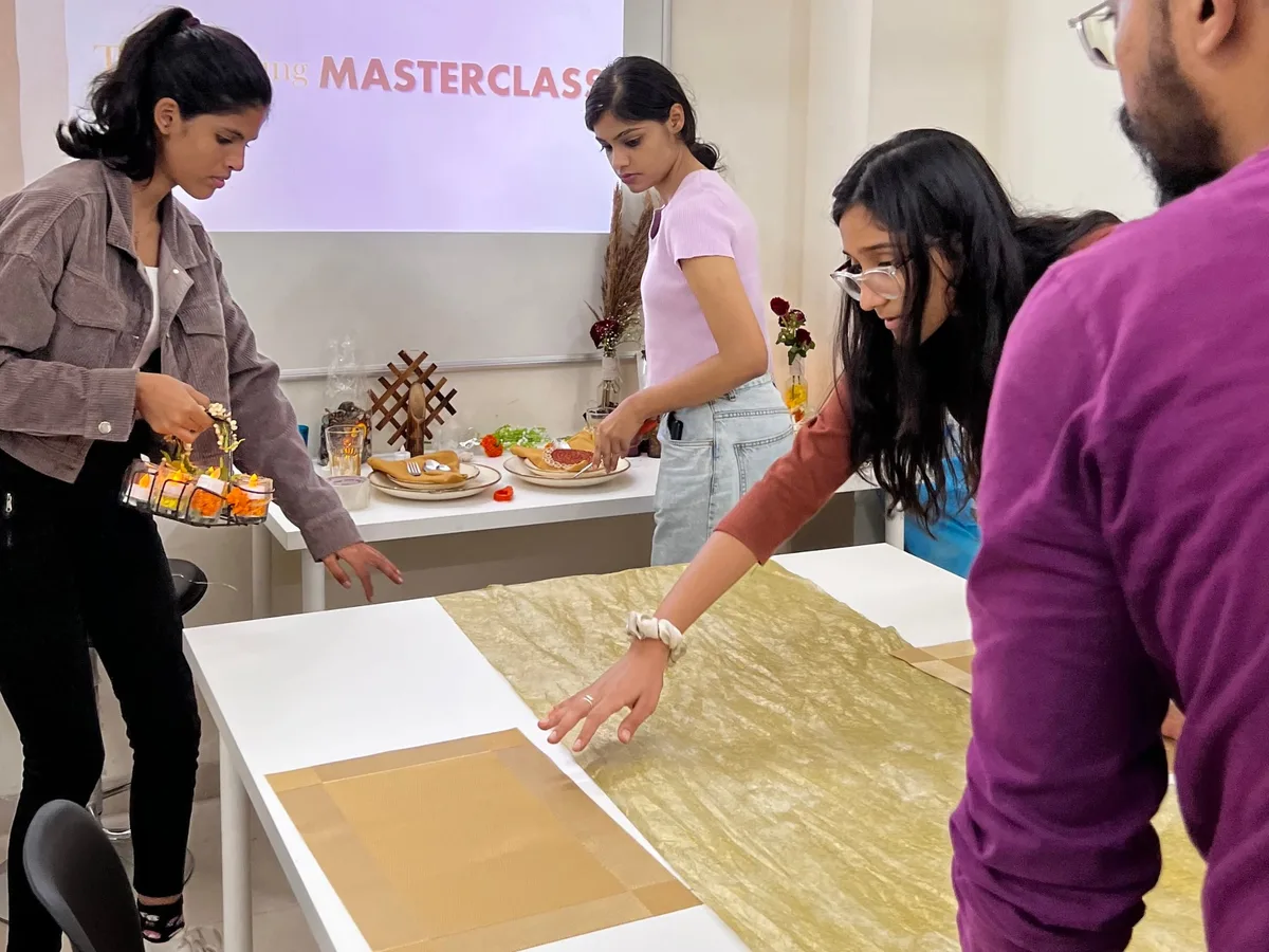 IIED wedding design students styling a tablescape in a masterclass